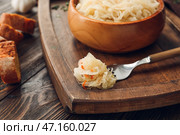 Вилка с вкусной квашеной капустой на деревянном столе. Стоковое фото, фотограф Pixel_shot / Фотобанк Лори