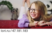 Child exploring smart watch functions while enjoying interesting and valuable gift from parents. Concept of technology experiences, cooperative learning, and digital engagement for young learners. Стоковое видео, видеограф Енваев Андрей / Фотобанк Лори