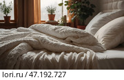 The interior of a modern house. A minimalistic cozy beige bedroom interior with a plaid, pillows, a headboard, linen linens and a bedside table. Стоковое AI-изображение, AI-художник Photojuli / Фотобанк Лори