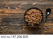 Чаша Кутьи и ложка на темном деревянном фоне. Стоковое фото, фотограф Pixel_shot / Фотобанк Лори