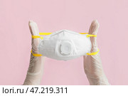 Руки врача с респиратором на цветном фоне. Стоковое фото, фотограф Pixel_shot / Фотобанк Лори