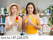 Young female friends choosing mosquito repellent in store. Стоковое фото, фотограф Яков Филимонов / Фотобанк Лори