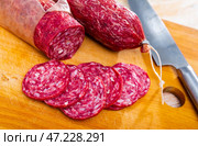Slices of dry-cured sausage from Iberian pork seasoned with natural marinades. Стоковое фото, фотограф Яков Филимонов / Фотобанк Лори