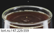 A rich coffee surface with a closeup of its beautiful drip effect, inviting admiration. Стоковое видео, видеограф Владимир Ковальчук / Фотобанк Лори
