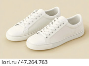 White leather lace-up running shoes with low tops, thick soles on a beige. The laces and rubber outsole. Sporty look. Men to wear during outdoor activities. Street hiking shoes. Trendy Male Boots Pair. Стоковое AI-изображение, AI-художник Марина Демидюк / Фотобанк Лори
