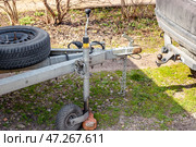 Passenger car next to the trailer coupling, metal drawbar with spare wheel, rolling wheel. Стоковое фото, фотограф Коханова Наталья / Фотобанк Лори