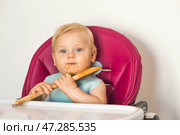 Baby food. The first meal. Feeding the baby. A cute little kid eats vegetables. Healthy food. The child is sitting on a high chair for feeding. Fresh vegetables and fruits. Стоковое фото, фотограф Photojuli / Фотобанк Лори