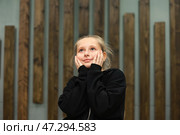 Young Girl Lost in Thought With a Curious Expression in a Creative Indoor Space. Стоковое фото, фотограф Aleksandr Golubev / Фотобанк Лори