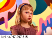 Young Girl Showcases Creativity With Colorful Backdrop in Vibrant, Playful Setting. Стоковое фото, фотограф Aleksandr Golubev / Фотобанк Лори
