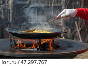 Picnic. Cook outdoors with friends using the backyard blacktop grill. The casual atmosphere showcases outdoor cooking. Стоковое фото, фотограф Оксана Медведева / Фотобанк Лори