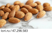 Nuts are arranged on a marble surface showcasing detailed textures. Орехи разложены на мраморной поверхности, демонстрирующей детальные текстуры. Стоковое AI-изображение, AI-художник Katsiaryna Repich / Фотобанк Лори
