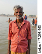 A wise-looking man enjoys the serene morning by the Ganges River in Varanasi, surrounded by fellow devotees engaging in various activities on the water Generative AI. Стоковое AI-изображение, AI-художник Юлия Петровская / Фотобанк Лори