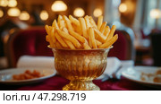 Golden fries served in a decorative bowl at a cozy restaurant. Золотистый картофель фри, поданный в декоративной миске в уютном ресторане. Стоковое AI-изображение, AI-художник Katsiaryna Repich / Фотобанк Лори