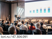 Speaker giving a talk in conference hall at business event. Rear view of unrecognizable people in audience at the conference hall. Business and entrepreneurship concept. Стоковое фото, фотограф Matej Kastelic / Фотобанк Лори