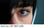 Close-up view of a person's eye reflecting light in a mirror setting. Крупный план глаза человека, отражающего свет в зеркале. Стоковое AI-изображение, AI-художник Katsiaryna Repich / Фотобанк Лори