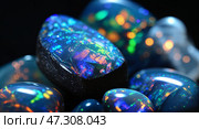 Colorful collection of opal stones showcasing their vibrant hues and patterns under bright lighting. Стоковое AI-изображение, AI-художник Сергей Толмачёв / Фотобанк Лори