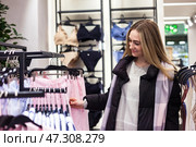 Exploring Fashion Choices Inside a Vibrant Mall With Creative Shopping Experiences. Стоковое фото, фотограф Aleksandr Golubev / Фотобанк Лори