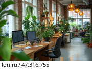 A cozy and modern office with an emphasis on ecology and comfort. The space is filled with living green plants: they are placed on window sills, shelves, tables and even hang from the ceiling. The interior combines loft elements: brick walls, large windows, wooden tables and designer lamps with a warm glow. There are monitors and office supplies at the workstations, which indicates real and active work. The atmosphere is harmonious, calm, conducive to creativity and concentration - as if this is an office of the future, in which man and nature coexist in balance. Стоковое AI-изображение, AI-художник Анна Кривицкая / Фотобанк Лори