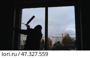 Silhouettes of a builder foaming a wall for installing windows. Стоковое видео, видеограф Mikhail Davidovich / Фотобанк Лори