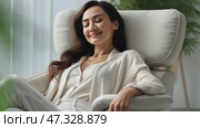 Happy millennial Caucasian woman sit in cozy chair in design home stretch relax breathe fresh air. Smiling young female renter or tenant rest in armchair relieve negative emotions enjoying weekend. Стоковое AI-видео, аниматор Sergey Grishin / Фотобанк Лори