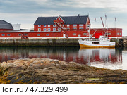 Cityscape of the town Henningsvaer, whaling and whaler boat, rocky coast with dramatic sky, classic view of Norwegian houses on the coast (2014 год). Стоковое фото, фотограф Vladimir Drozdin / Фотобанк Лори