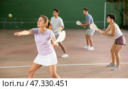 Woman Basque pelota player hitting ball with wooden racket. Стоковое фото, фотограф Яков Филимонов / Фотобанк Лори