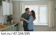 Emotional Dance. Middle-aged Couple Dancing Together Embrace at Home. Mature Couple dancing bonding, smiling and moving to the rhythm in a romantic vibe enjoying their anniversary. Active relationship. Стоковое видео, видеограф Марина Демидюк / Фотобанк Лори