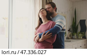 Mature couple hugging hugging each other kissing at home bedroom. Intimate Moment. Tender embrace shared between a loving middle age man and woman, husband and wife. Deep love. Low key, cinematic. Стоковое видео, видеограф Марина Демидюк / Фотобанк Лори