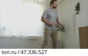 Handsome bearded man dance, have fun at home listens song, moves to music, feels overjoyed, celebrate good news, relish carefree life looks happy. Young adult male twirls, grooves. Brutal man dancer. Стоковое видео, видеограф Марина Демидюк / Фотобанк Лори