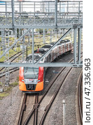 Electric passenger train of the Moscow central railway circle drives at urban landscape. Редакционное фото, фотограф Константин Григорьев / Фотобанк Лори