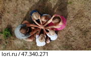 A friendly family joins hands together as a sign of the unity and strength of the family. Drone view. Стоковое фото, фотограф Mikhail Davidovich / Фотобанк Лори
