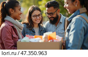 Four friends gather in a park, smiling and laughing as they exchange supportive words while handing over a box of essential supplies for a charitable activity. Стоковое AI-изображение, AI-художник Sergey Grishin / Фотобанк Лори