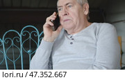 Portrait of senior man using mobile phone, holding device, texting, surfing internet. Old male looking at web camera, talking online. Elderly person chatting. Modern technologies and older generation. Стоковое видео, видеограф Марина Демидюк / Фотобанк Лори