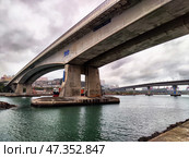 Lantau Island, Hong Kong - April 09, 2024: View of Lantau Island bridge under cloudy skies in Hong Kong's harbor area during daytime. Редакционное фото, фотограф Кривошеина Елена Леонидовна / Фотобанк Лори