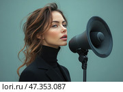 A young woman with an expressive appearance and a calm, confident look, standing next to a large black megaphone directed in her direction. She is dressed in a black turtleneck and a black jacket, which emphasizes the severity and elegance of the image. Her hair is gathered in a slightly careless hairstyle, a few strands softly frame her face. The background is monochromatic, in a calm green-turquoise shade, which makes the composition minimalistic and stylish. The image evokes associations with the concept of "voice", expression of opinion, public statement. Стоковое AI-изображение, AI-художник Анна Кривицкая / Фотобанк Лори