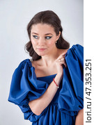 Elegant Portrait of a Woman in Striking Blue Attire, Showcasing Her Style in a Studio Setting. Стоковое фото, фотограф Aleksandr Golubev / Фотобанк Лори