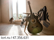 Guitar. Guitar chords. Acoustic guitar. Music. Musical background. An image of an acoustic guitar in a room with a retro armchair. Hard light. Shadows. Стоковое фото, фотограф Photojuli / Фотобанк Лори