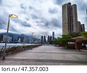 Lantau Island, Hong Kong - April 09, 2024: Lantau Island waterfront in Hong Kong features modern skyscrapers and moody skies. Редакционное фото, фотограф Кривошеина Елена Леонидовна / Фотобанк Лори