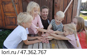 A friendly family joins their hands as a sign of joint success. Стоковое фото, фотограф Mikhail Davidovich / Фотобанк Лори