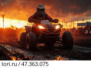 A spectacular moment of the ATV race. A rider in a helmet and protective gear rushes along a mud track on a powerful ATV, raising splashes and clods of earth. The sun sets behind the horizon, painting the sky and everything around in fiery orange and golden tones. The light of the headlights and the dirt on the equipment emphasize the dynamics and intensity of what is happening. In the distance, a crowd of spectators, flags and elements of the track are visible. The scene is filled with energy, speed and drive. Стоковое AI-изображение, AI-художник Анна Кривицкая / Фотобанк Лори