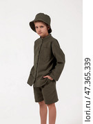 Children’s Fashion Concept Featuring a Boy Wearing a Stylish Outfit Indoors in a Studio Setting. Стоковое фото, фотограф Aleksandr Golubev / Фотобанк Лори