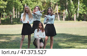 Funny schoolgirls posing and goofing around in a meadow. Стоковое фото, фотограф Mikhail Davidovich / Фотобанк Лори