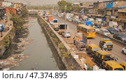 Mumbai, India - December 17, 2018 Dirty river in Dharavi slums. Mumbai. India. Редакционное фото, фотограф Mikhail Davidovich / Фотобанк Лори