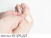 A patch on a man's leg. Protection against calluses on the foot. Стоковое фото, фотограф Александр Поташев / Фотобанк Лори