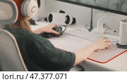 Gamer adjusts settings using customizable gaming keypad while controlling mouse for precision gameplay. Professional setup enhances gaming experience with responsive controls and modern equipment. Стоковое видео, видеограф Енваев Андрей / Фотобанк Лори