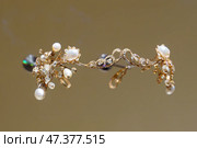 Doha, Qatar - Jan 06 2024, a close up view of historical vintage royal jewellery, the tiara, crown, exhibits of National Museum of Qatar, on monochrome background, under the glass, Doha, Qatar. Редакционное фото, фотограф Сергей Богомяко / Фотобанк Лори