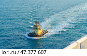 Manama, Bahrain - Jan 08 2024, Aerial view of tugboat, boat, what passing by, with blue sea, at daytime, Manama, Bahrain. Редакционное фото, фотограф Сергей Богомяко / Фотобанк Лори