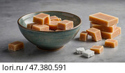 Delicious assortment of handmade fudge arranged in a bowl and on a countertop. Стоковое AI-изображение, AI-художник Сергей Толмачёв / Фотобанк Лори