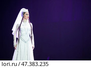 Belarus, Gomel, February 27, 2018. Concert hall. Speech of the national Georgian ballet Sukhishvili.A Georgian woman in a national white costume dances Georgian dance. Редакционное фото, фотограф Лазаренко Светлана / Фотобанк Лори