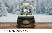 Detailed snow globe with lit house scene in white brown and green representing festive holiday cheer with copy space. Стоковое AI-видео, аниматор KATERINA AI / Фотобанк Лори
